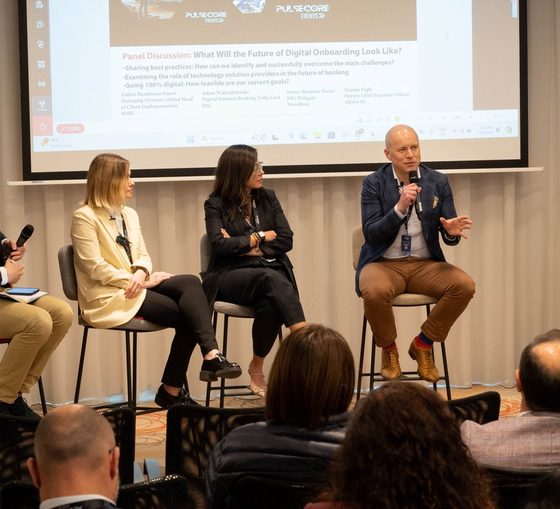 Five panellists seated on stools in front of the audience at a previous Excellence in Digital Banking summit