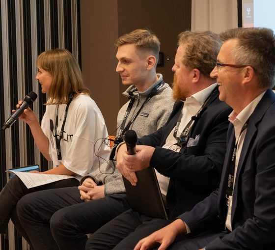 Four panellists seated with microphones during a discussion at a previous Excellence in Digital Banking summit